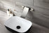 Grifo para lavabo de baño en cascada de níquel cepillado con desagüe emergente de latón y montaje en pared.