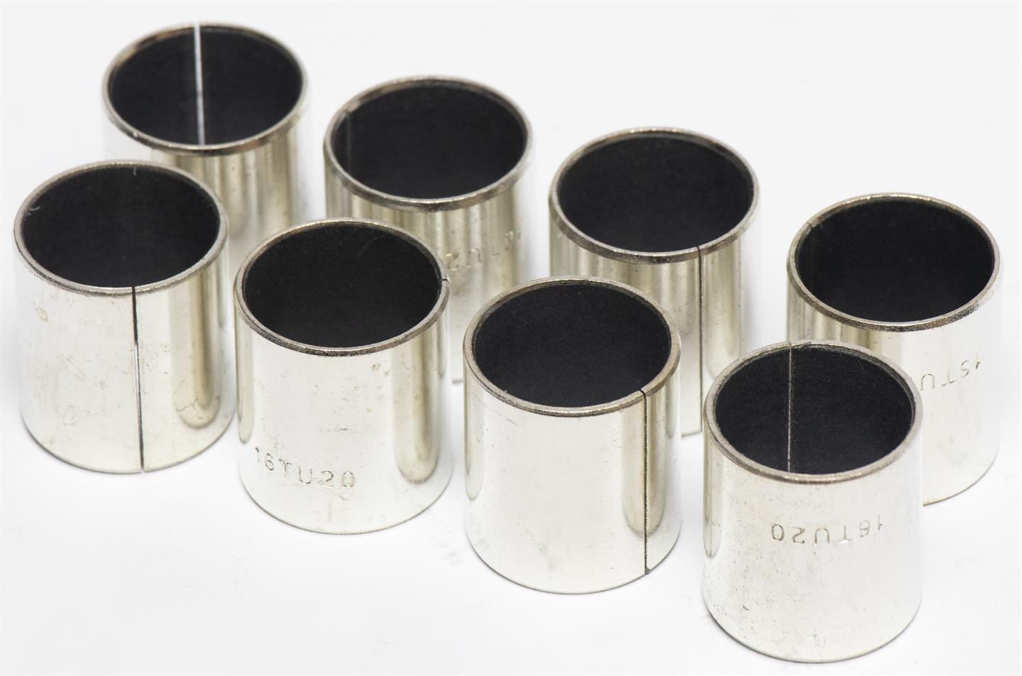 Set of metal bushings with black inserts on a white background