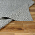 Alfombra trenzada de yute sintético en color carbón crema
