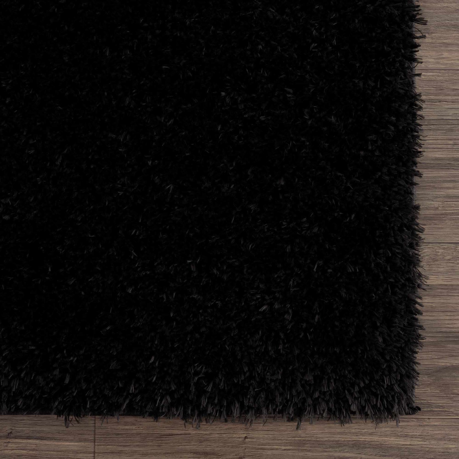 Alfombra peluda Faina de color negro liso lavable