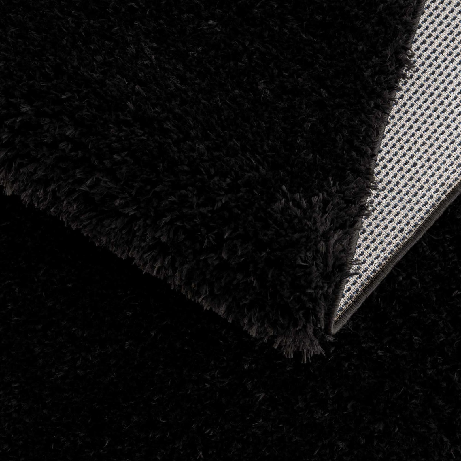 Alfombra peluda Faina de color negro liso lavable