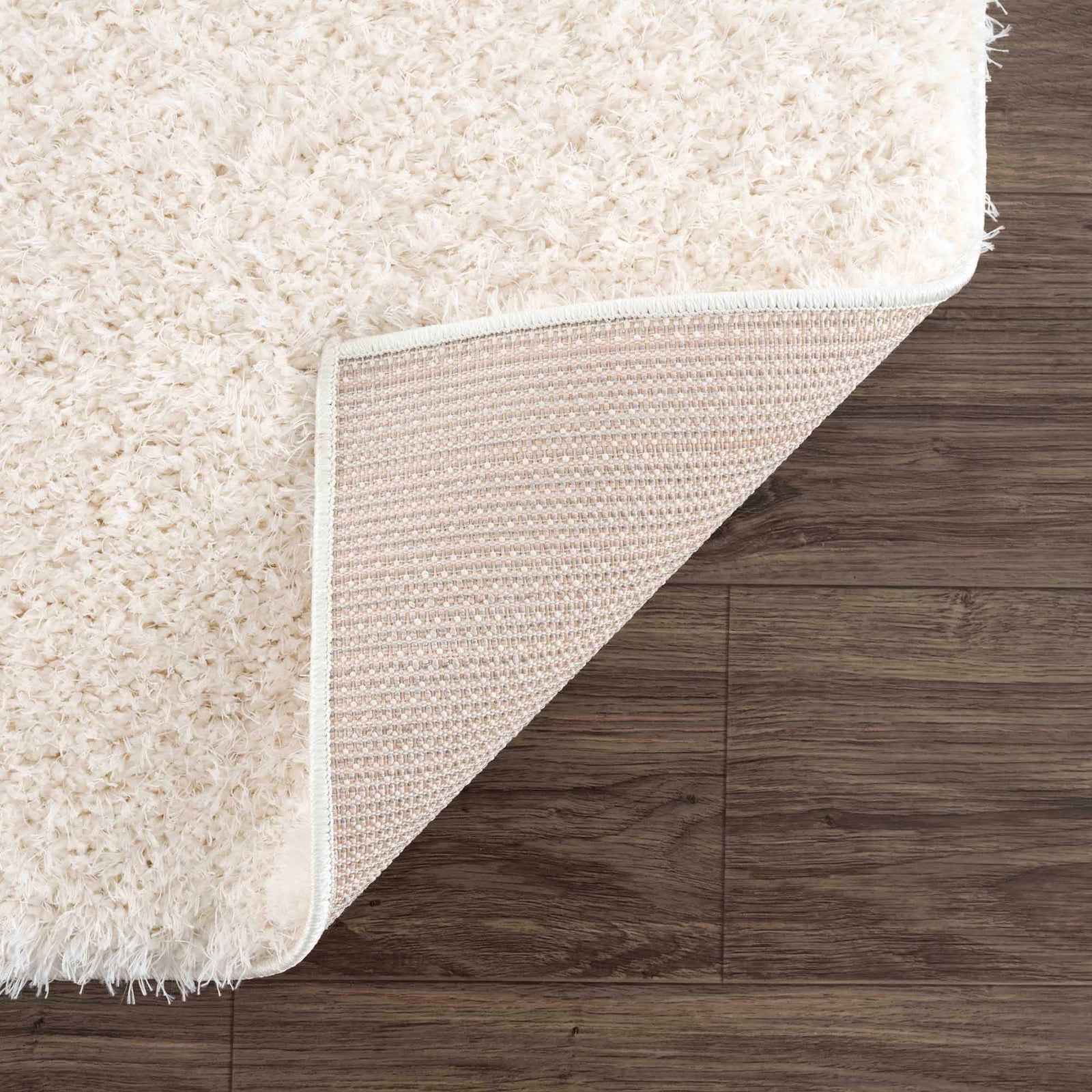 Alfombra peluda Faina de color crema sólido lavable