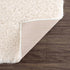Alfombra peluda Faina de color crema sólido lavable