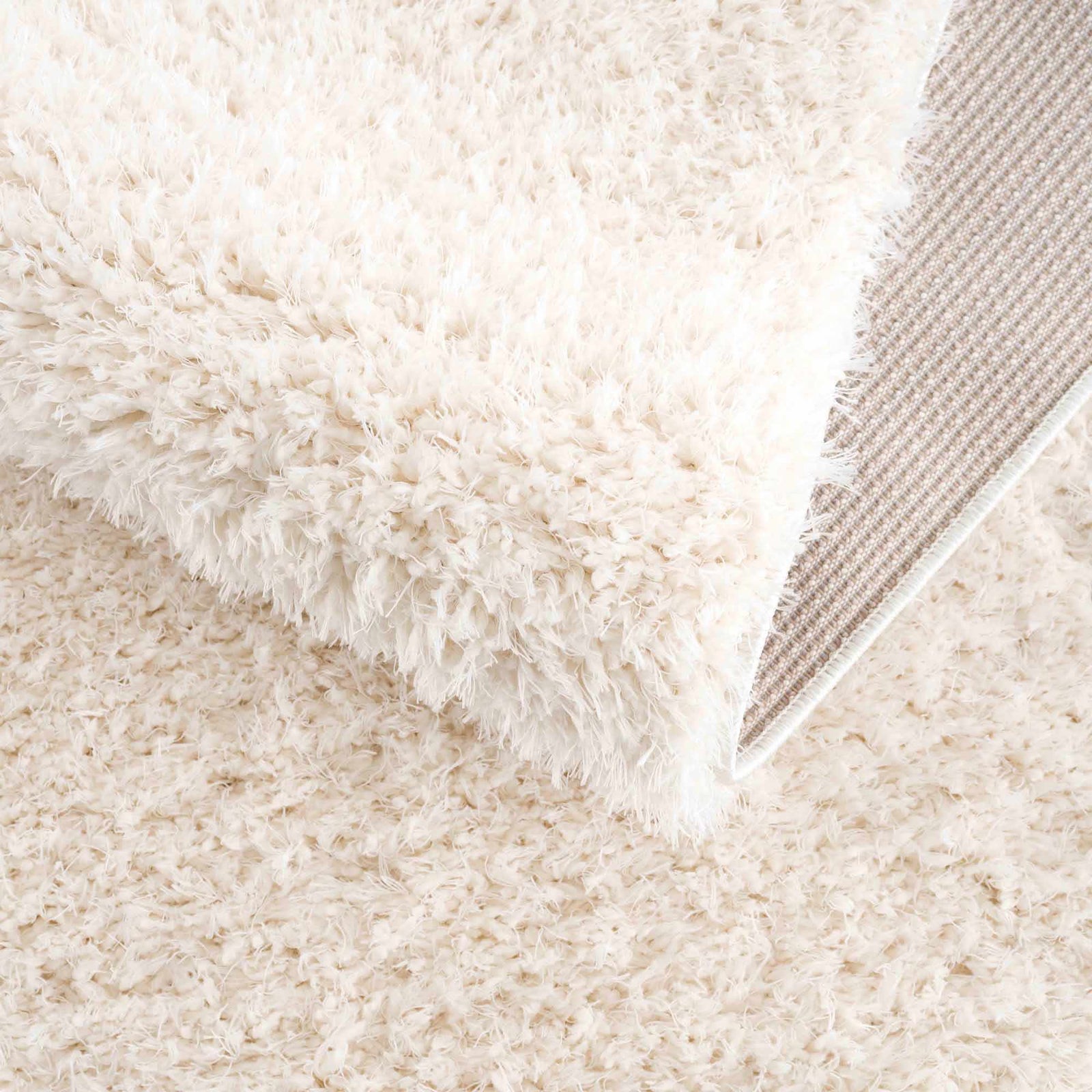 Alfombra peluda Faina de color crema sólido lavable