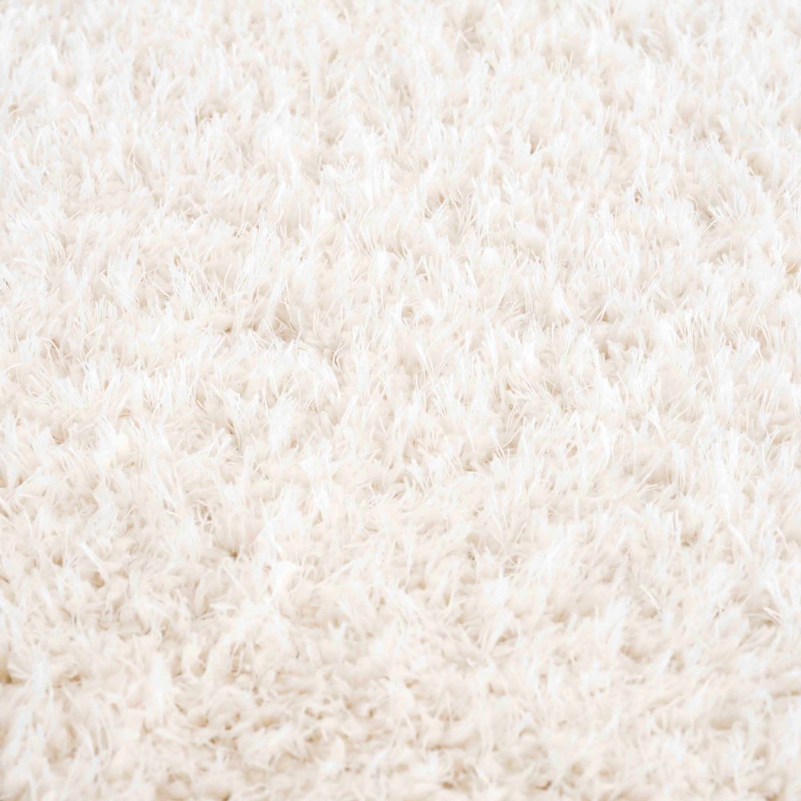 Alfombra peluda Faina de color crema sólido lavable