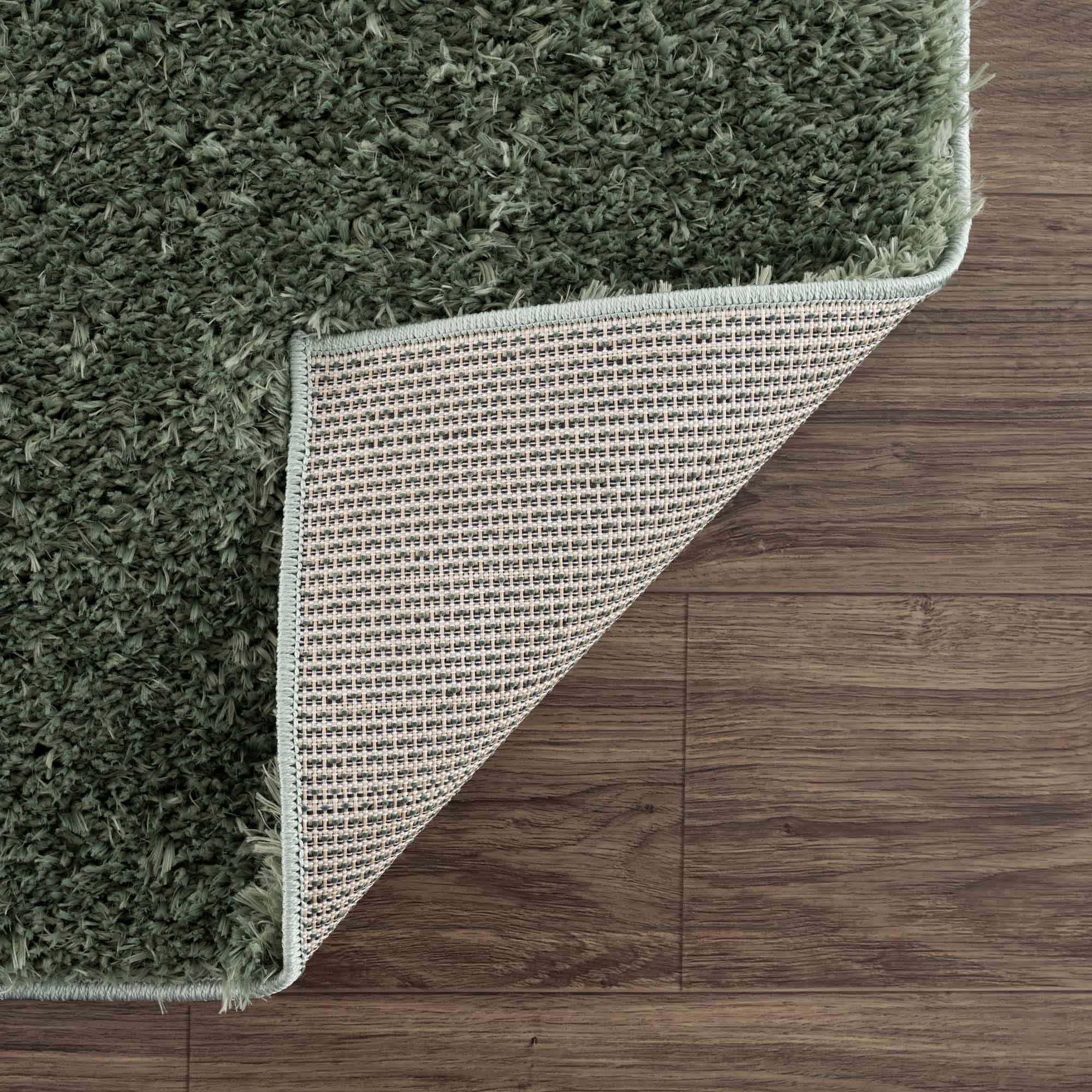 Alfombra peluda lavable Faina de color verde sólido