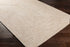 Alfombra trenzada de yute sintético de color crema