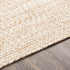 Alfombra trenzada de yute sintético de color crema